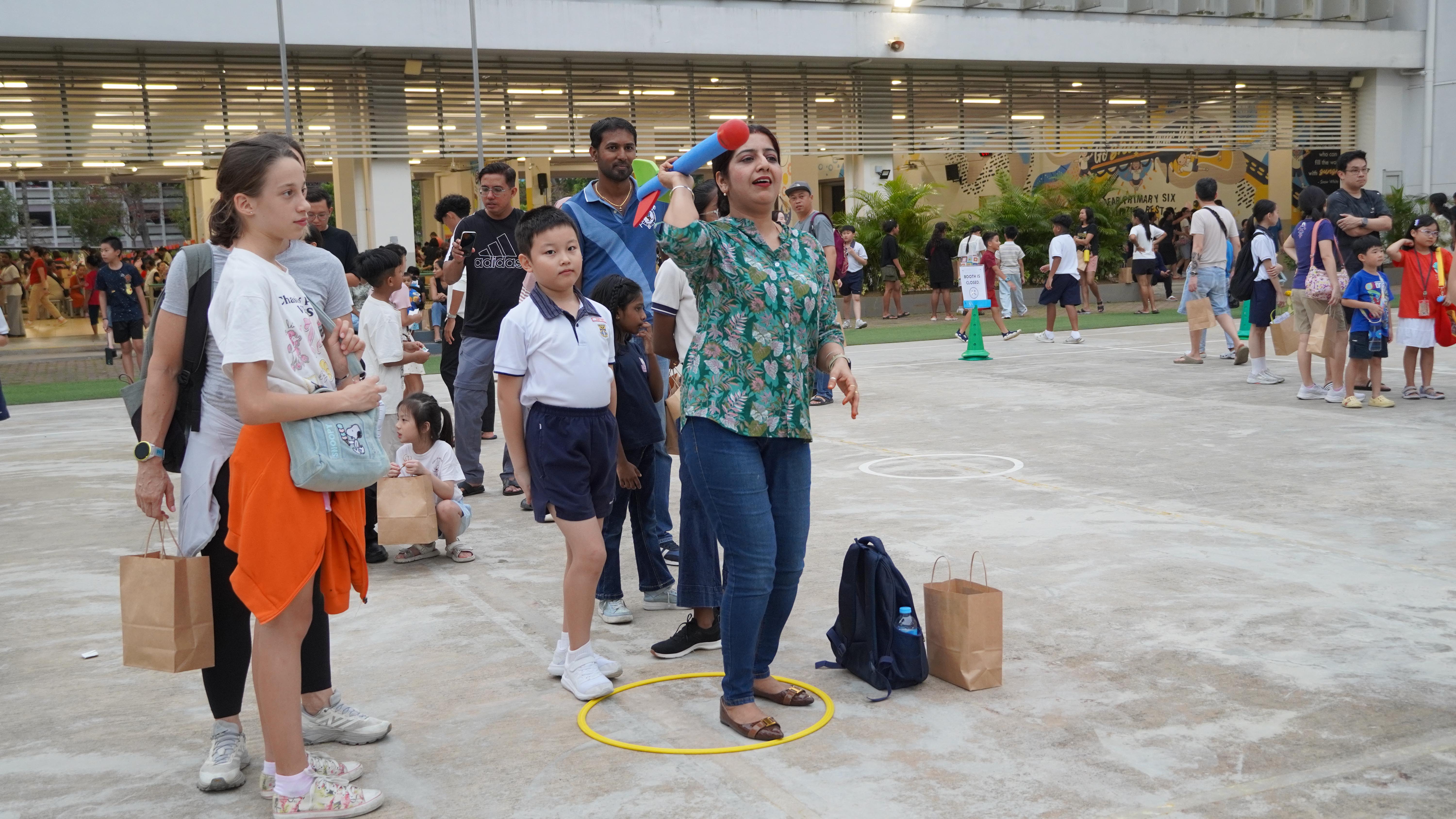 It’s not just for the children! Parents get in on the action and show that carnival games are fun at any age.